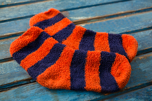 Close up of striped pattern socks on wooden table