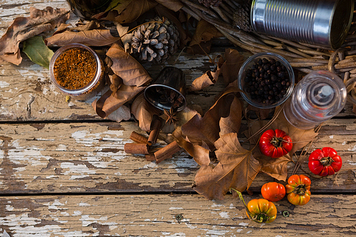 Overhead view of spice by container on wooden table