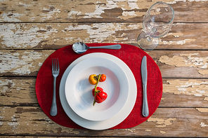 Overhead view of tomatoes served in plate on wooden table