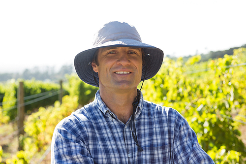 Portrait of handsome farmer smiling in field on a sunny day