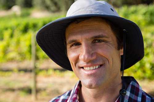 Portrait of handsome farmer smiling in field on a sunny day