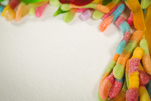 Overhead close up of colorful jelly candies over white background
