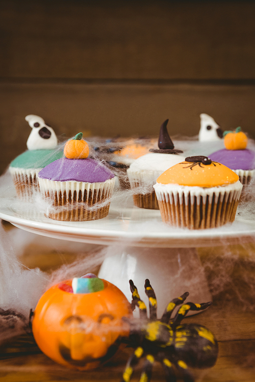 Close up of sweet food arranged on wooden table during Halloween