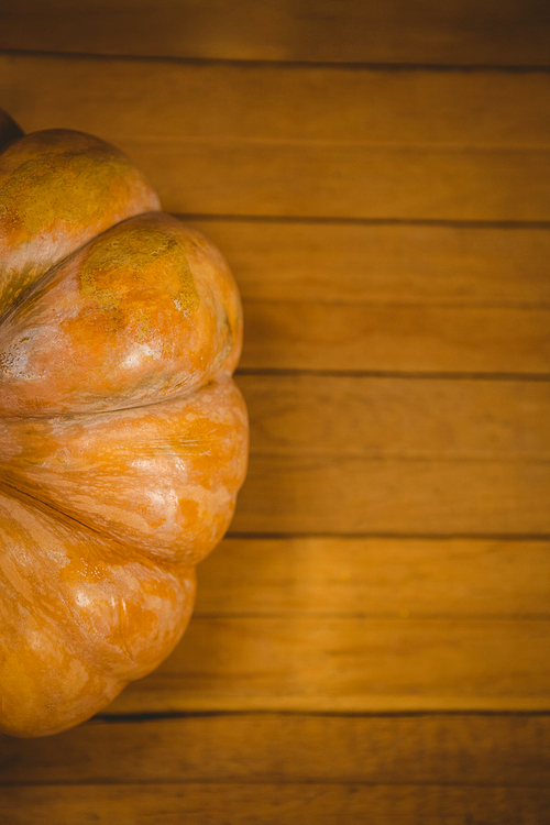 Overhead view of pumpkin on wooden table