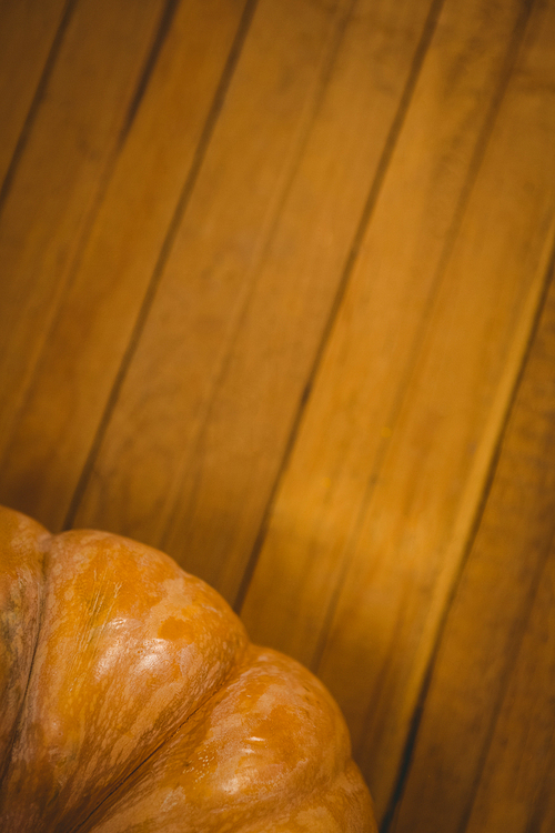 Cropped image of pumpkin on wooden table