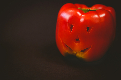 Close up of carved red bell pepper on black background