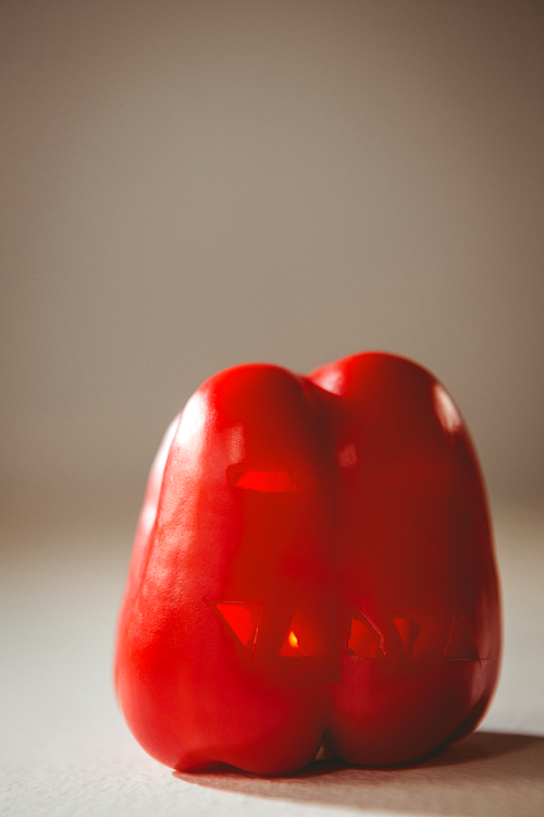 Close up of carved red bell pepper over white background