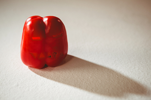 High angle view of carved red bell pepper over white background