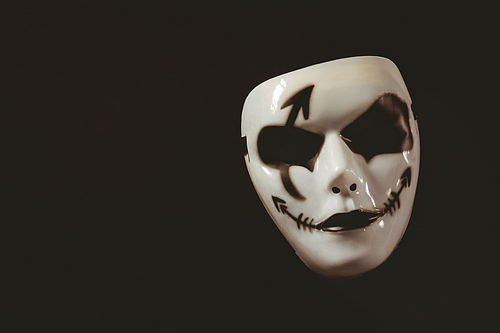 High angle view of evil mask on black background