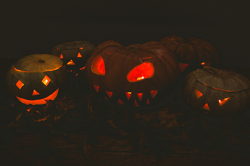 Illuminated jack o lanterns in darkroom during Halloween