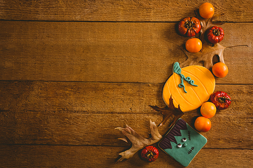 Overhead view of food with autumn leaves on wooden table