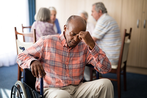 depressed disabled senior man sitting on . at retirement home
