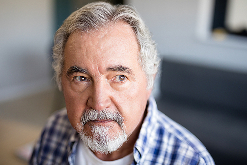 Thoughtful senior man looking away at nursing home