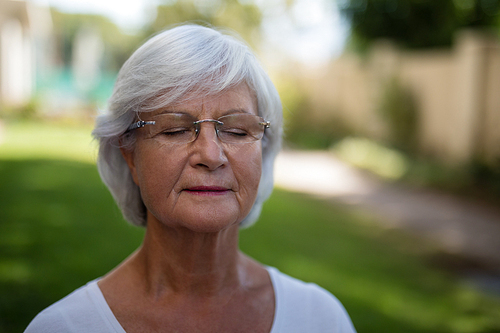 Close-up of senior woman with closed eyes at park