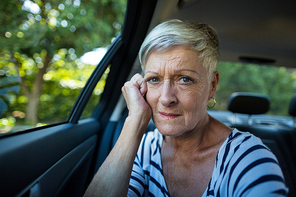 Portrait of tensed senior woman siting in car