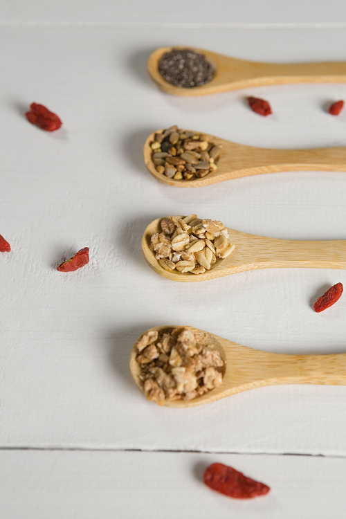 Close-up of various oatmeal in wooden spoon