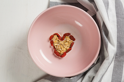 Overhead of dried fruits forming heart shape in plate