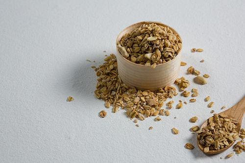 Close-up of oat flakes in a wooden bowl and spoon