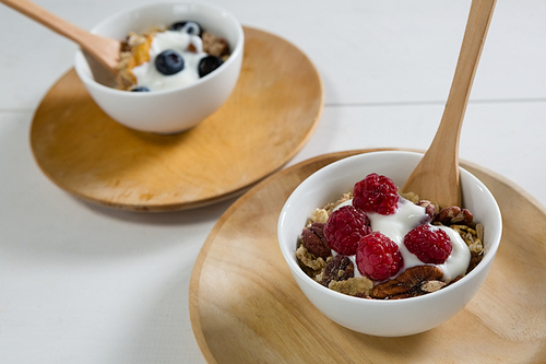 Two bowls of breakfast cereals on white background