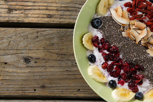 Close-up of healthy breakfast in bowl on wooden table
