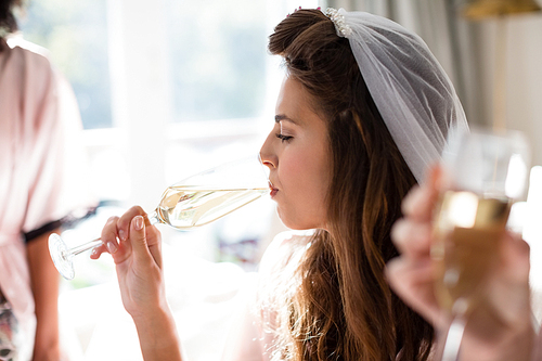 Women drinking a glasses of champagne at home