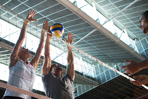 Low angle view of players practicing volleyball at court