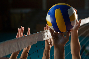 Cropped hands of players practicing volleyball at court