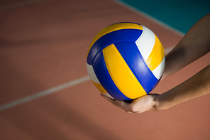 Cropped hands of player with volleyball at court