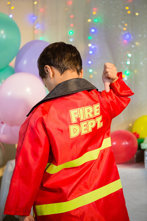 Rear view of boy gesturing to the text on protective workwear
