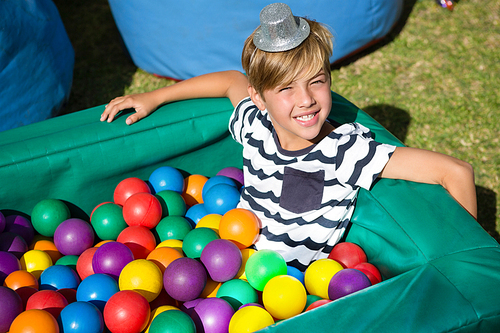 Portrait of smiling boy in ball pool during party