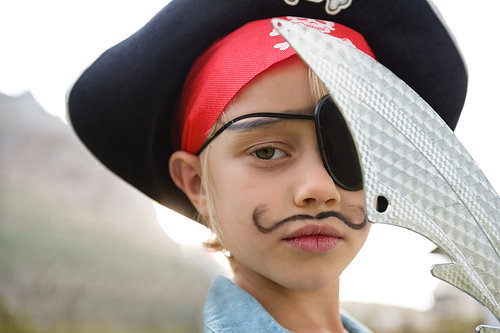 Close up portrait of boy wearing pirates costume during birthday party in yard