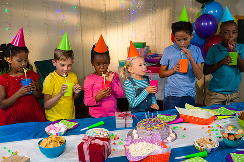 Children having drink during birthday party