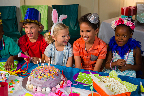 Cheerful children at table during birthday party