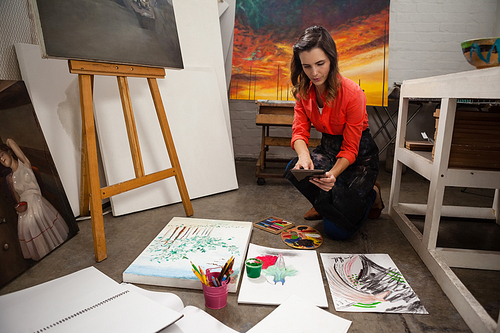 Young woman using digital tablet in drawing class