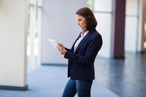 Businesswoman using digital tablet at conference centre