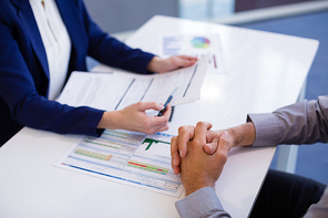 Close-up of business executives discussing over document