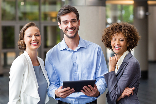 Portrait of business executives holding digital tablet at conference centre