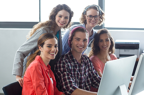 Portrait of smiling business executives working in office