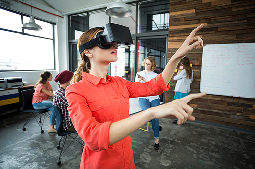 Business executive using a virtual reality headset in office