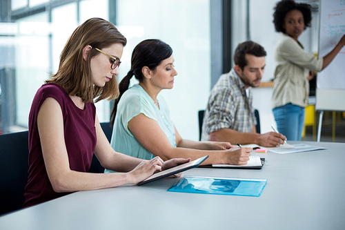 Business executive using digital tablet in meeting at office