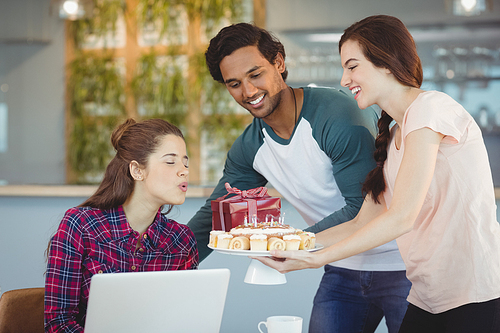 Business executives celebrating their colleagues birthday in office