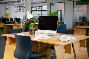 Personal computer and landline on desk in creative office