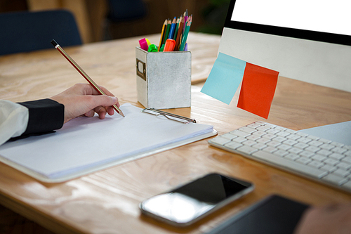 Close-up of a female graphic designer working at desk in creative office