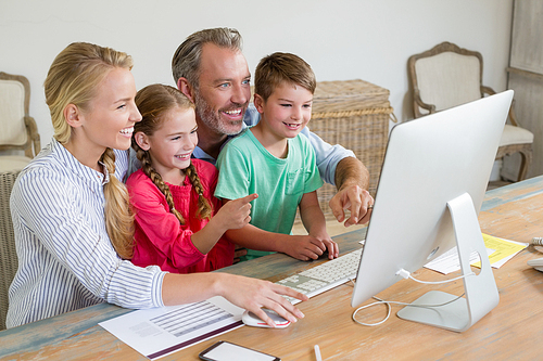 Happy family using computer at home