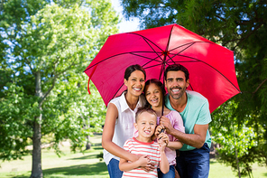 Portrait of happy family enjoying time together in the park on a sunny day