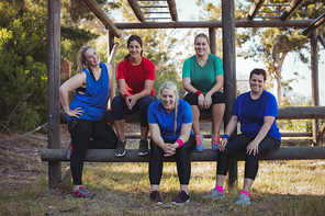 Group of fit women relaxing together in the boot camp on a sunny day