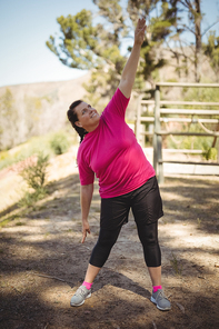 Woman exercising during obstacle course in boot camp