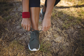 Woman wearing shoes after workout during obstacle course in boot camp