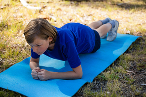 Girl exercising on exercise mat during obstacle course training in the boot camp