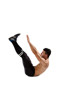 Full length of sports player exercising while lying on white background